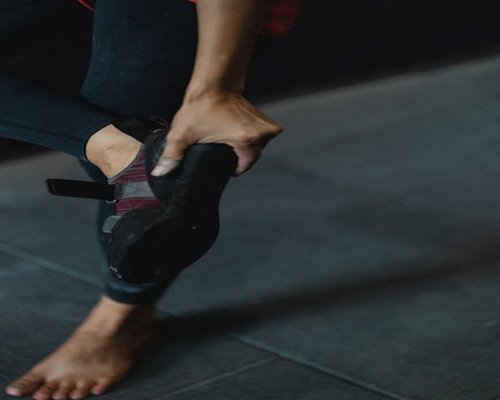 A person taking off their shoes after a long day of walking in the city